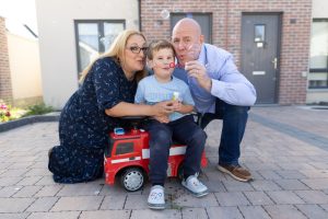 The O'Mahoney family blow bubbles together outside their home