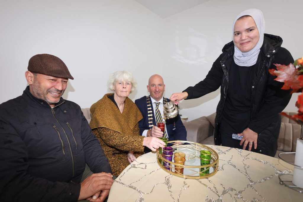 Tuath residents and staff with local authority representative enjoy tea together