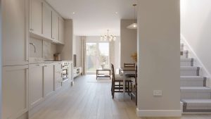 Kitchen and dining area in a home at Cornamaddy Court Phase 2, with fitted units, oven and hob, a dining table, and French doors to the rear garden
